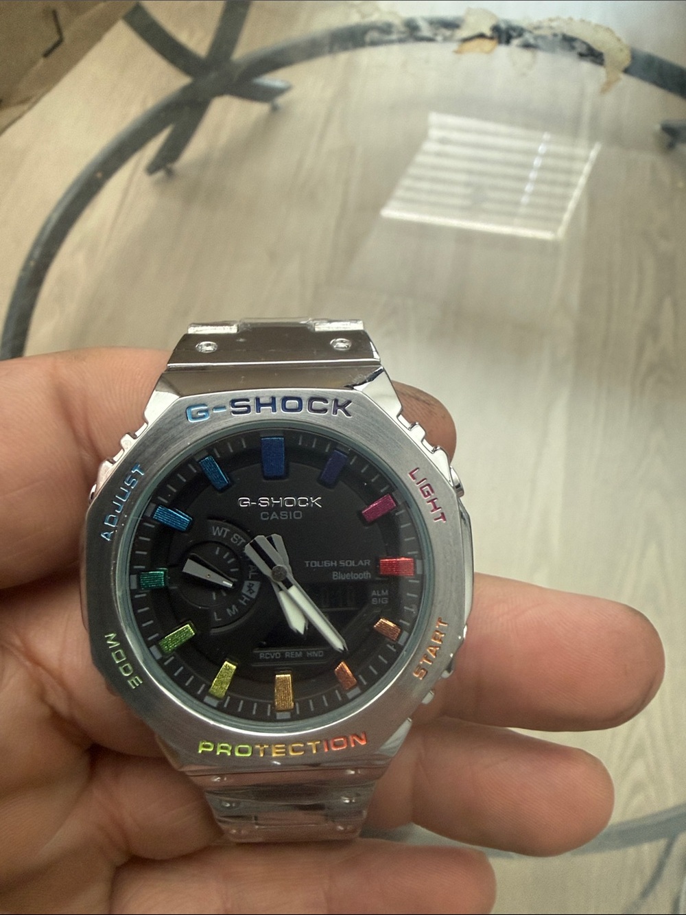 G-Shock Silver Stainless Steel Watch with Black Dial and Rainbow Hour Markers